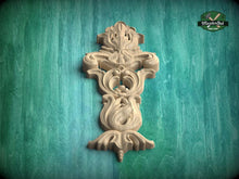 Load image into Gallery viewer, A decorative wooden carving or panel with intricate floral and scrollwork designs, set against a green textured background.
