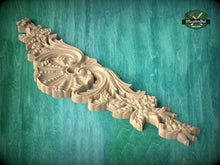 Load image into Gallery viewer, A decorative wooden carving with intricate floral and leaf patterns is displayed against a teal background.
