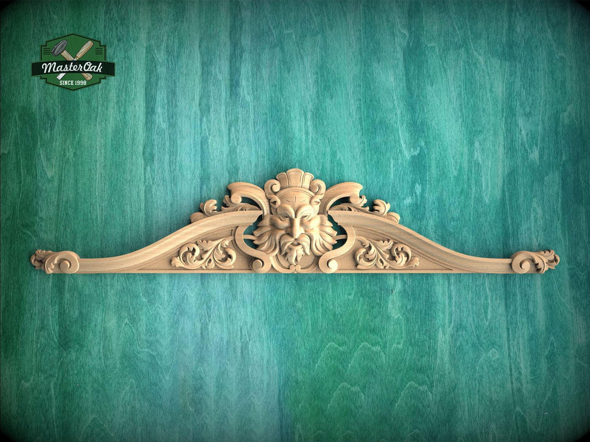 a carved wooden mold or sculpture with an intricate design, set against a green textured background.