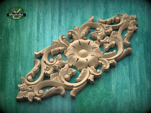 Load image into Gallery viewer, a beautifully carved wooden piece with intricate floral and leaf designs, set against a green background.

