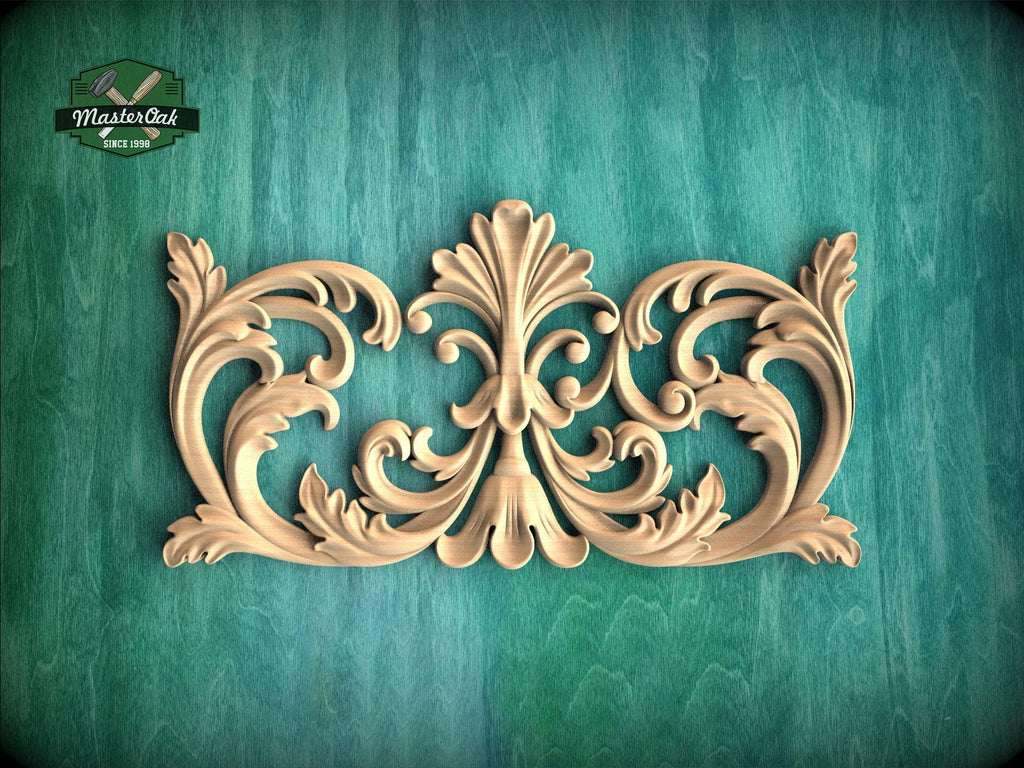 an ornate, carved wooden design with intricate scrollwork and floral elements, set against a green textured background.