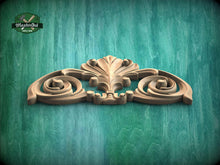 Load image into Gallery viewer, A decorative wooden carving with an intricate, ornate design is displayed against a green background.

