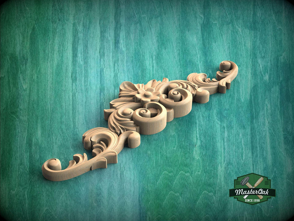 A decorative wooden carving with intricate scrollwork and floral elements is displayed against a green textured background.