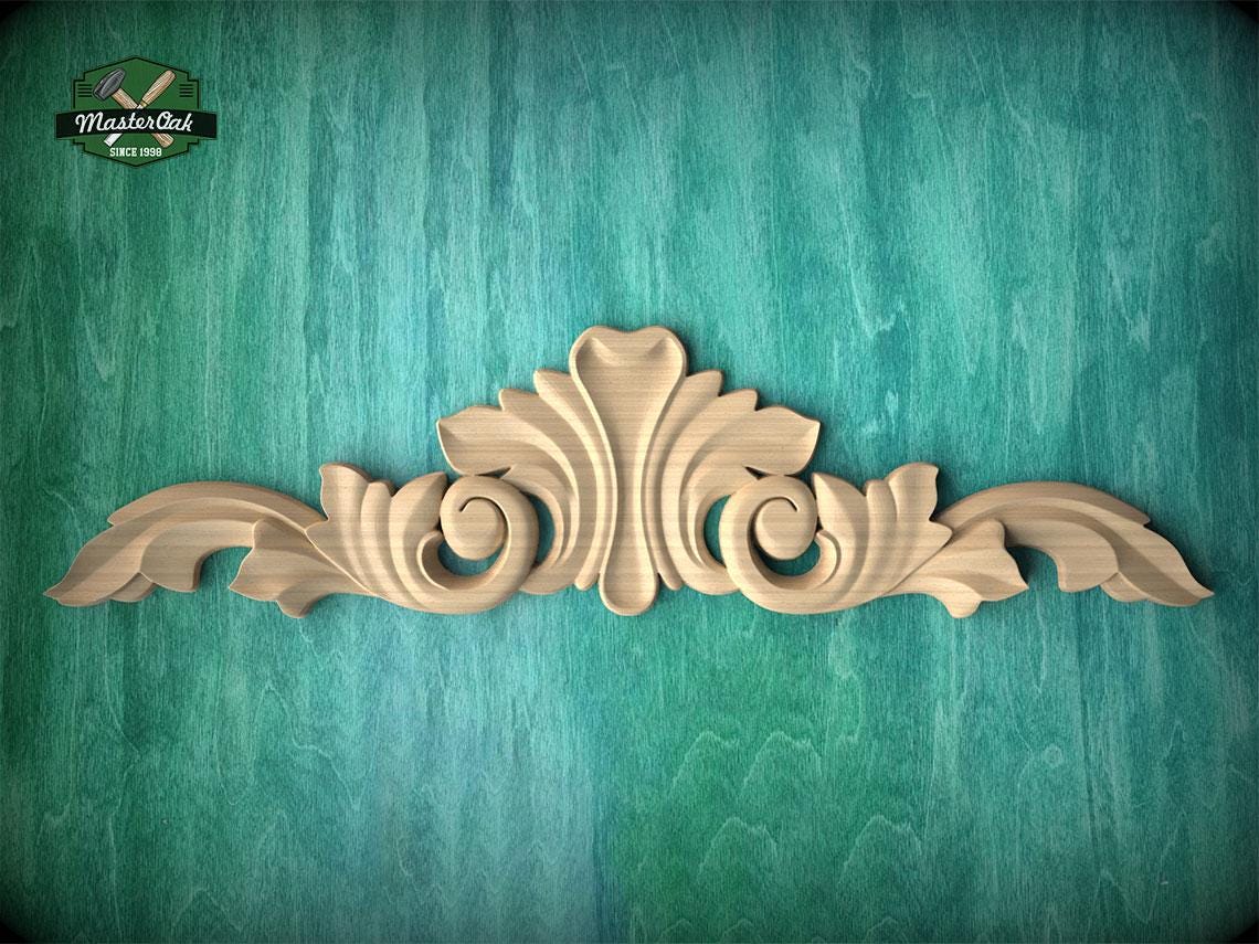 a decorative wooden carving on a green textured background.