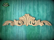 Load image into Gallery viewer, a decorative wooden carving on a green textured background.
