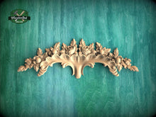 Load image into Gallery viewer, a decorative wooden carving on a green background.
