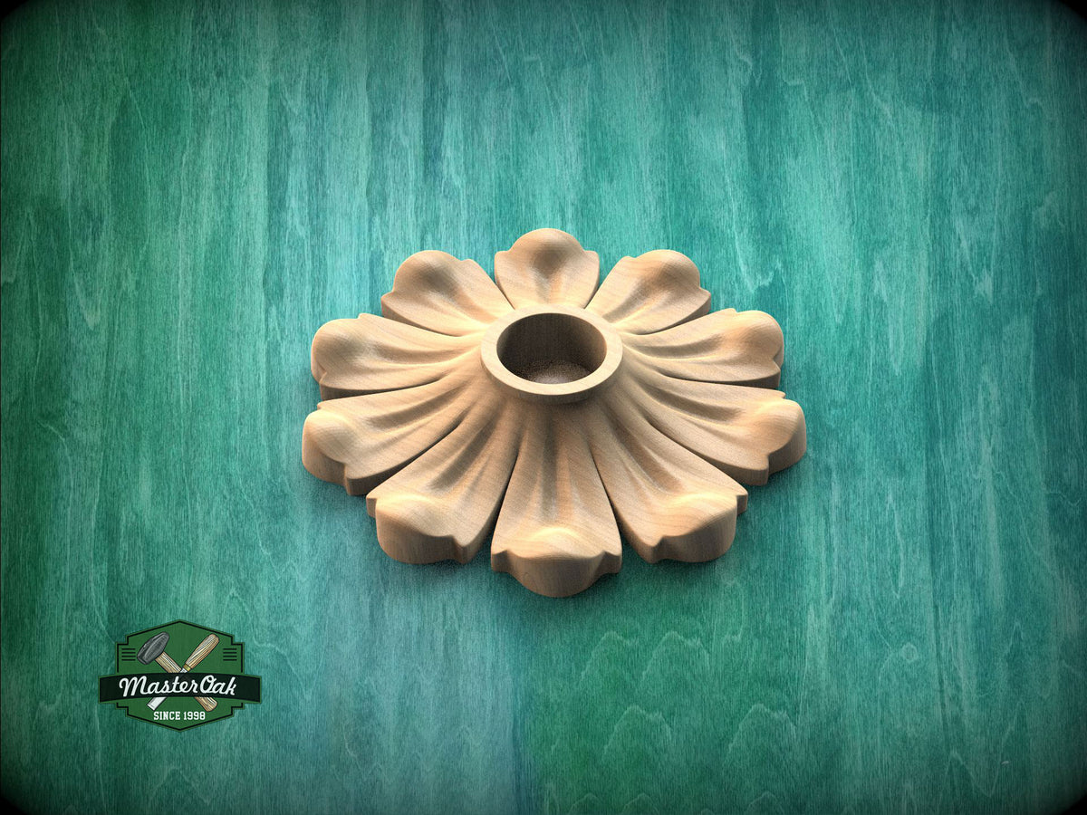 a wooden flower-shaped object with a round center, set against a green background.