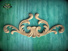 Load image into Gallery viewer, a decorative wooden carving on a green background.
