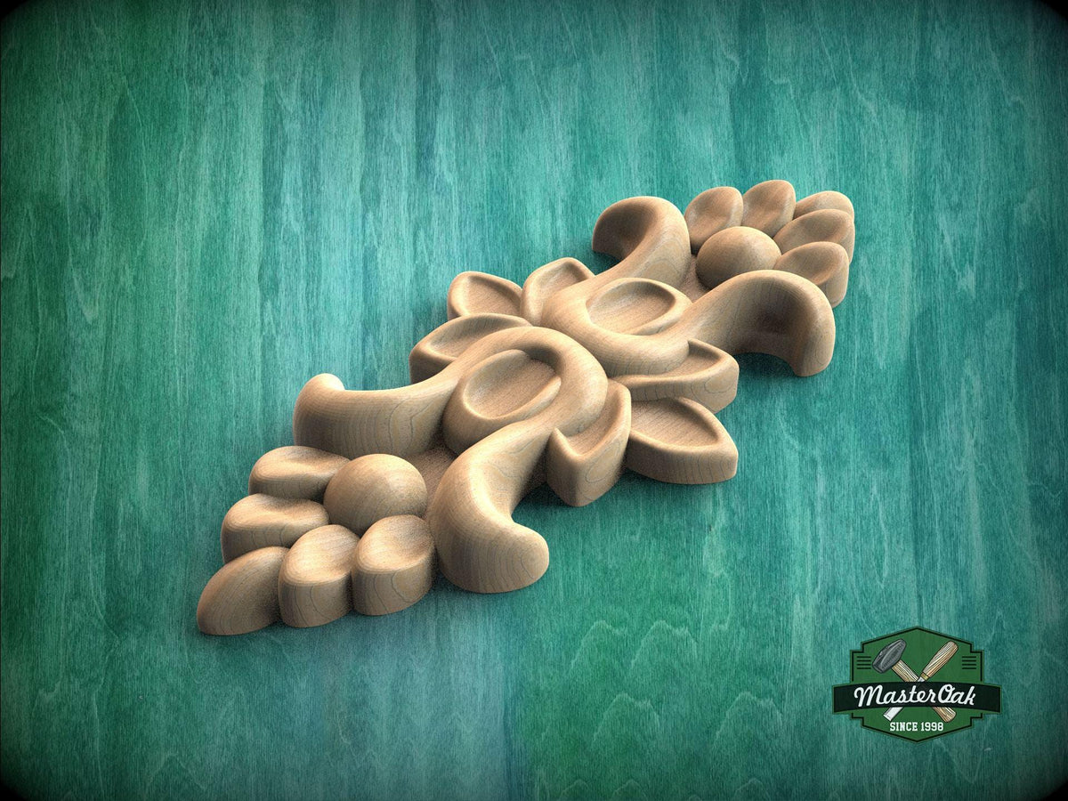 A wooden carving with intricate floral designs is displayed against a green background.
