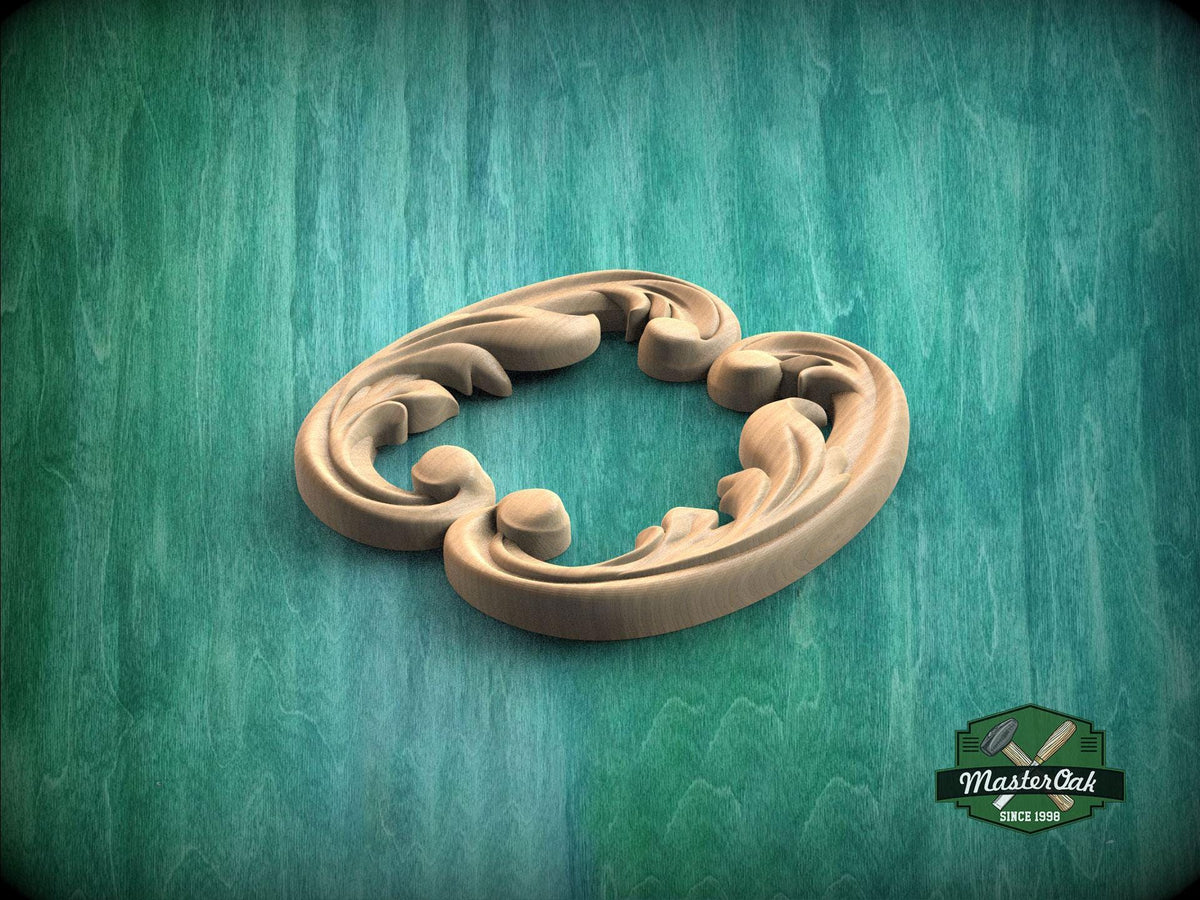 A wooden carving of a stylized leaf or flower design is displayed against a green background.