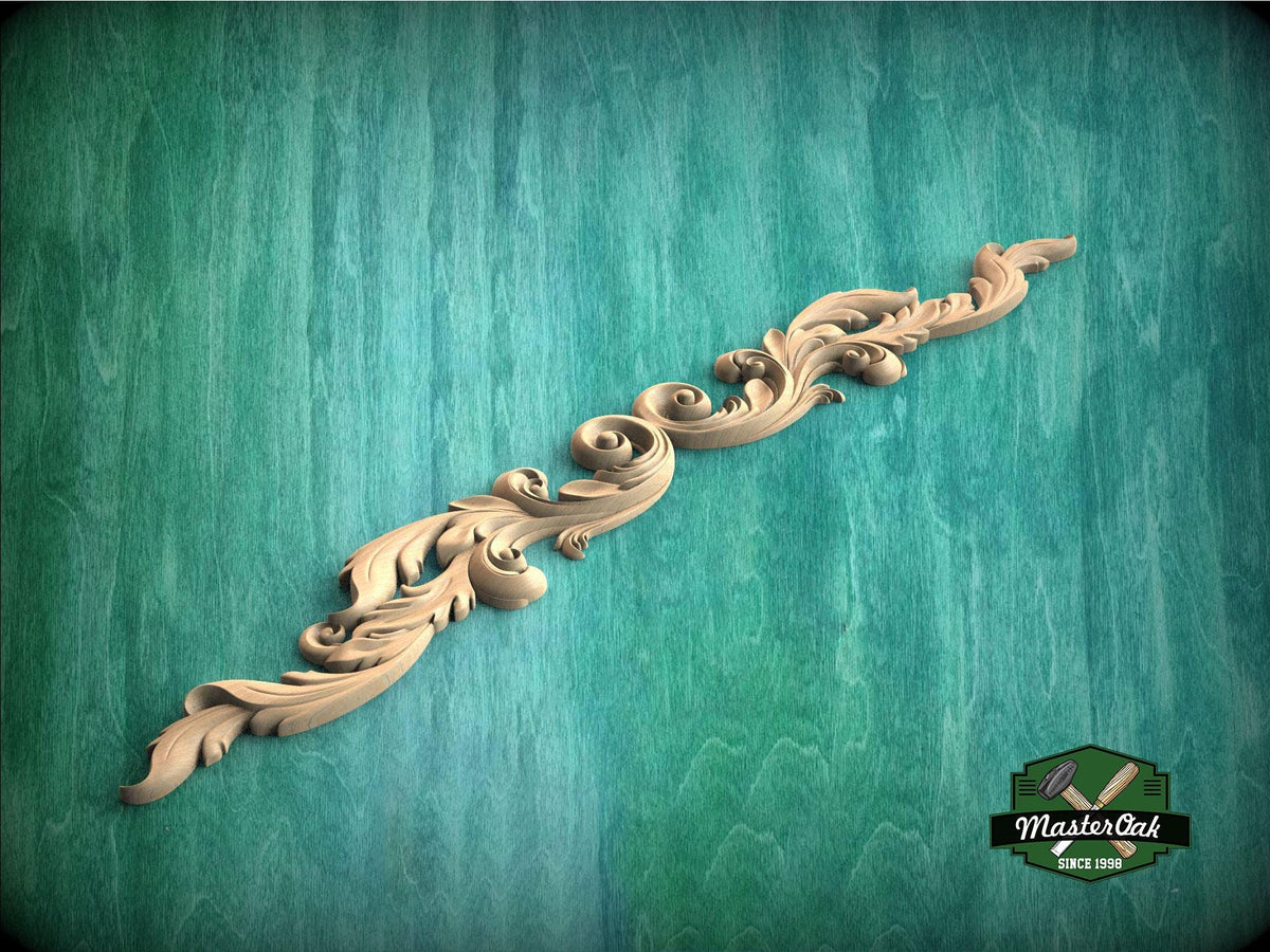 A decorative wooden carving in the shape of a scroll or ribbon is displayed against a green textured background.