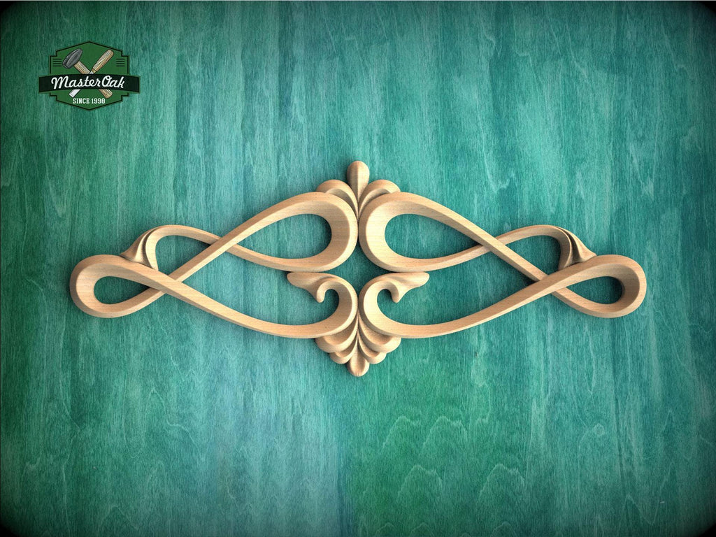 an ornate, carved wooden design with a floral motif, displayed against a green textured background.