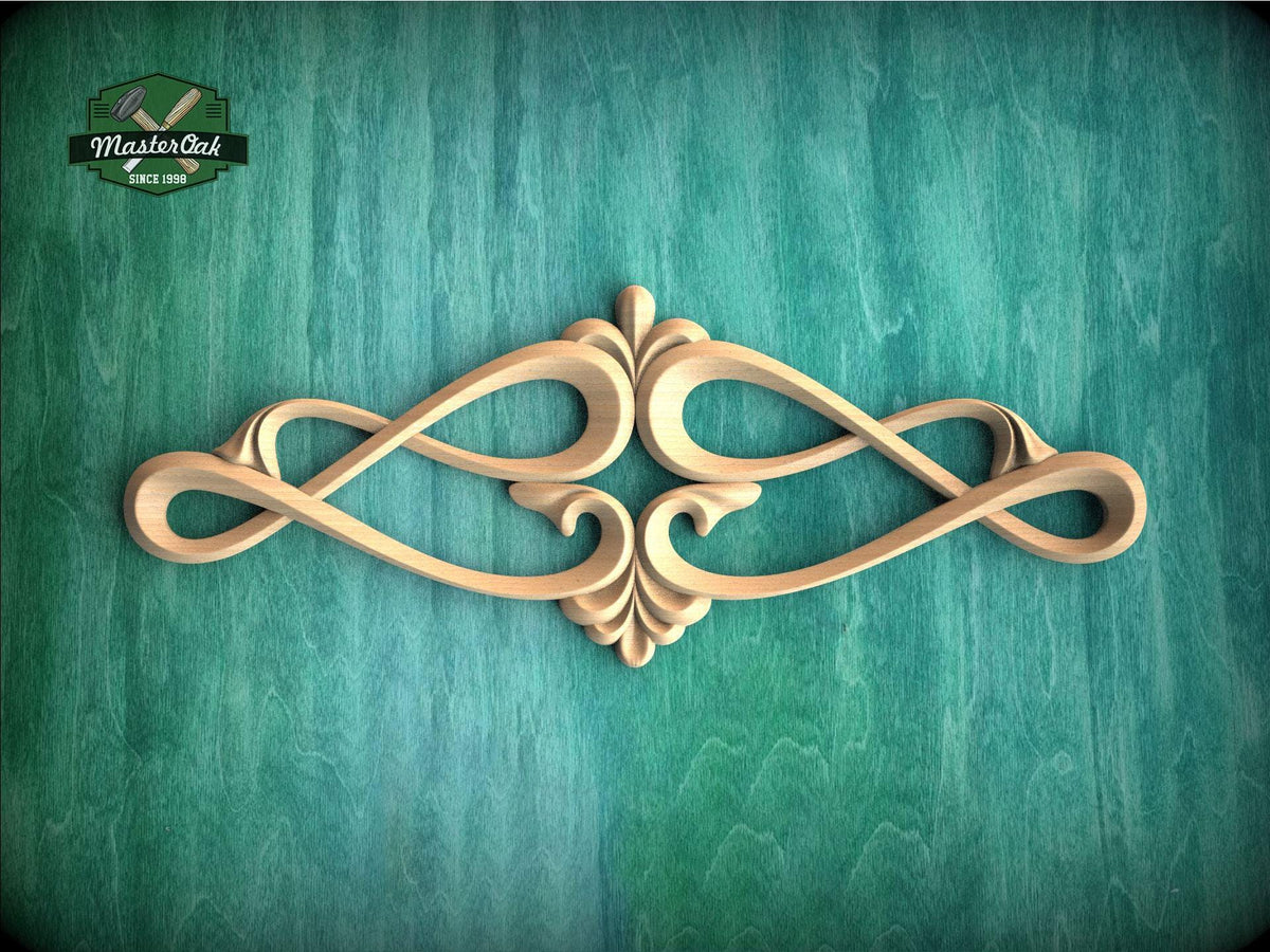 an ornate, carved wooden design with a floral motif, displayed against a green textured background.