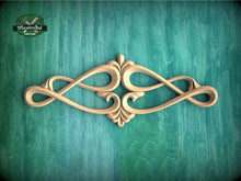 Load image into Gallery viewer, an ornate, carved wooden design with a floral motif, displayed against a green textured background.
