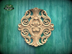 a decorative wooden carving on a green background.