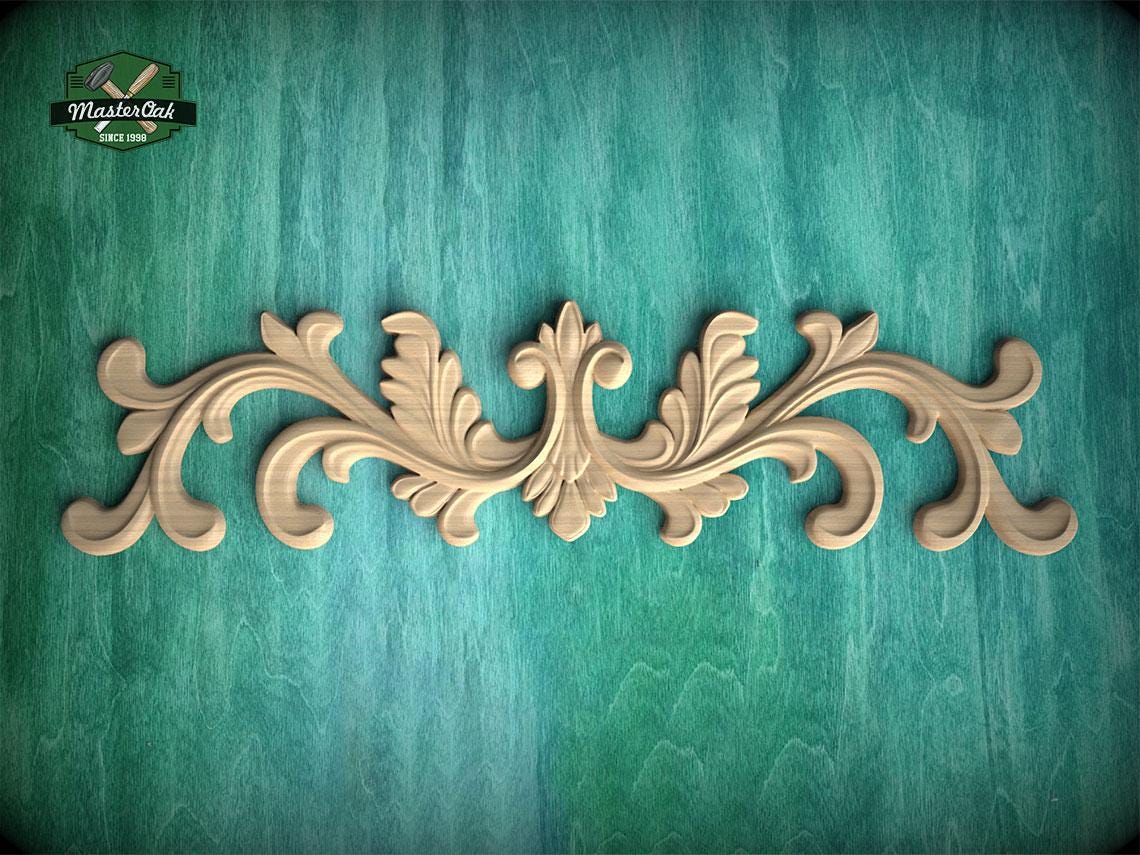 a decorative wooden carving on a teal background.