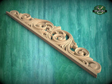 Load image into Gallery viewer, A decorative wooden carving with intricate scrollwork is displayed against a green textured background.
