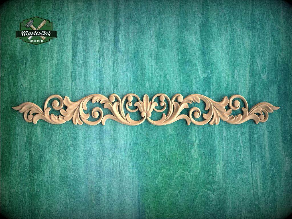 A decorative wooden carving with an intricate floral design is displayed against a textured green background.