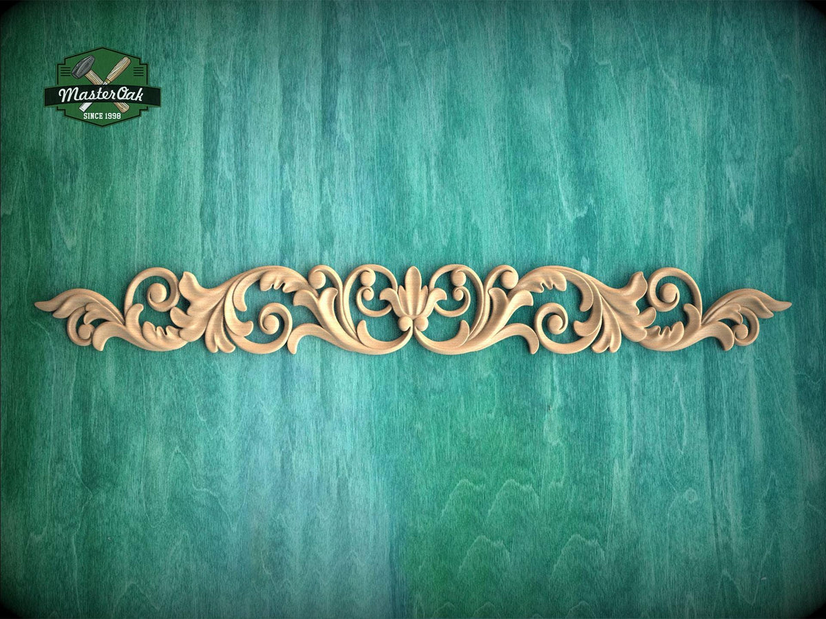 A decorative wooden carving with an intricate floral design is displayed against a textured green background.