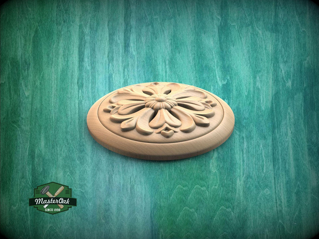 a wooden ornamental piece with a floral design, placed on a green textured background.