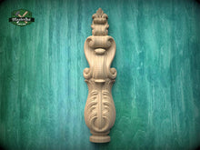 Load image into Gallery viewer, a wooden carving of a decorative finial or finial-like object, which is mounted on a green wooden surface.
