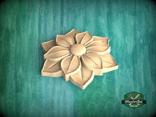 Load image into Gallery viewer, A wooden flower-shaped carving is displayed against a green background.
