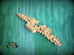 a wooden carving of a dragon on a green background