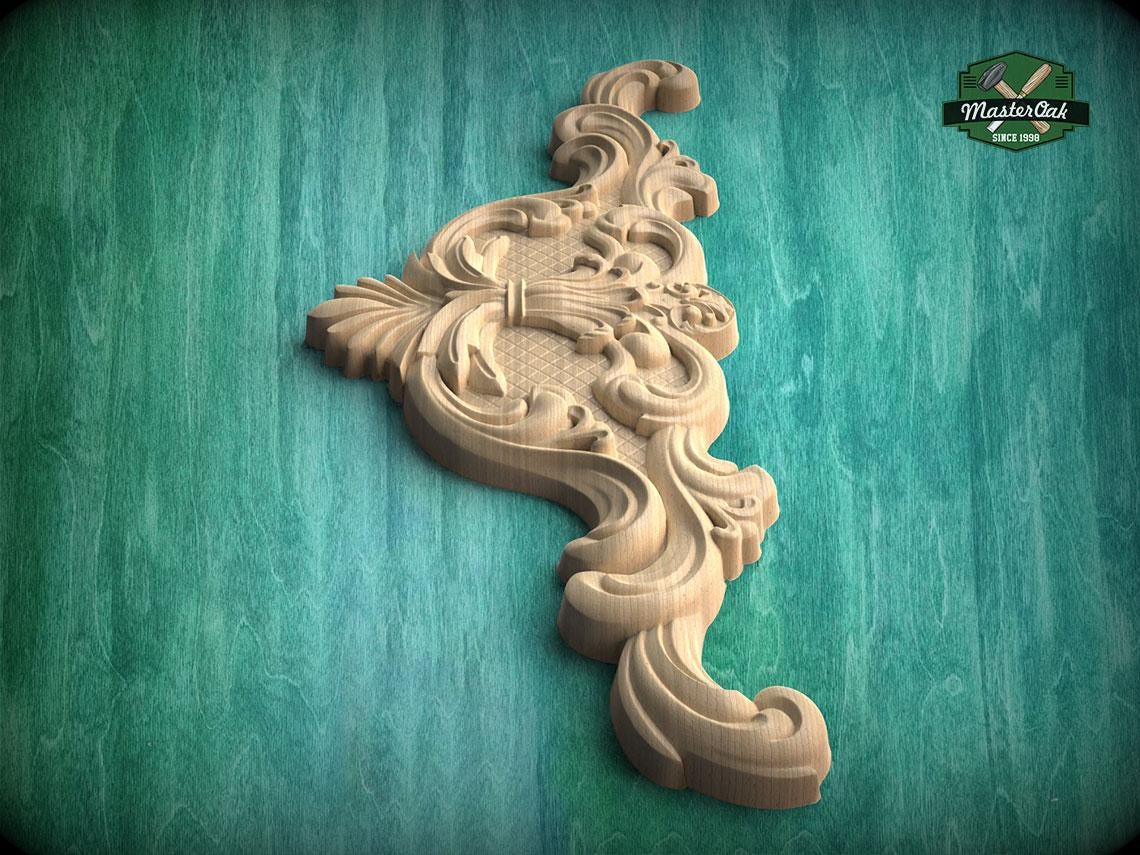A decorative wooden carving with intricate floral and scrollwork designs is displayed against a green background.