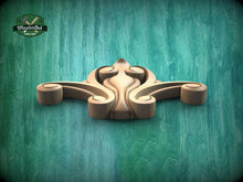 Load image into Gallery viewer, A wooden carving of an octopus or squid with curled tentacles is displayed against a green background.
