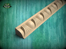 Load image into Gallery viewer, A wooden carving with a curved, wave-like design is displayed against a green background.
