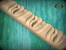 Load image into Gallery viewer, A wooden carving with a curved, organic design is displayed against a teal background.
