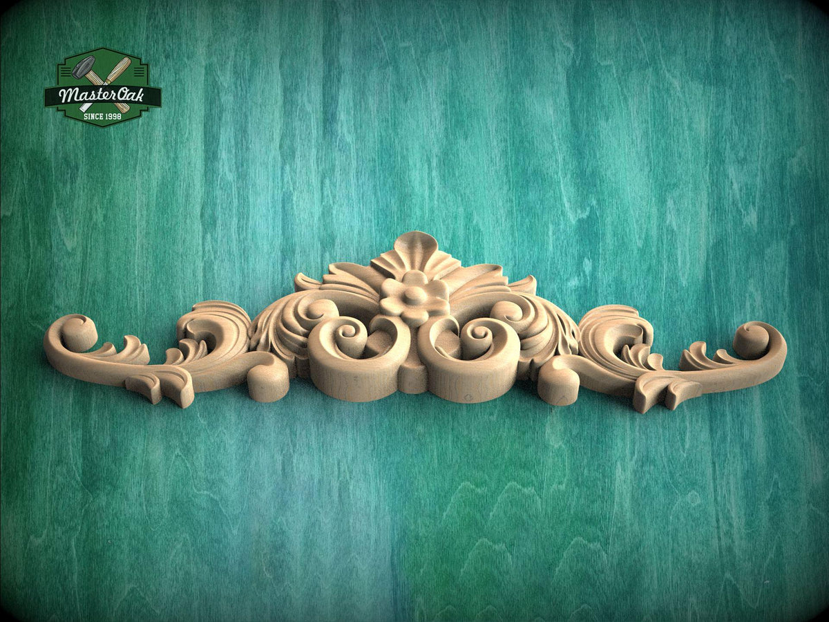 A decorative wooden carving with intricate scrollwork and floral elements is displayed against a green textured background.