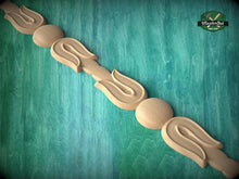 Load image into Gallery viewer, A wooden decorative element with a curved design, resembling a flower or leaf shape, is displayed against a green textured background.
