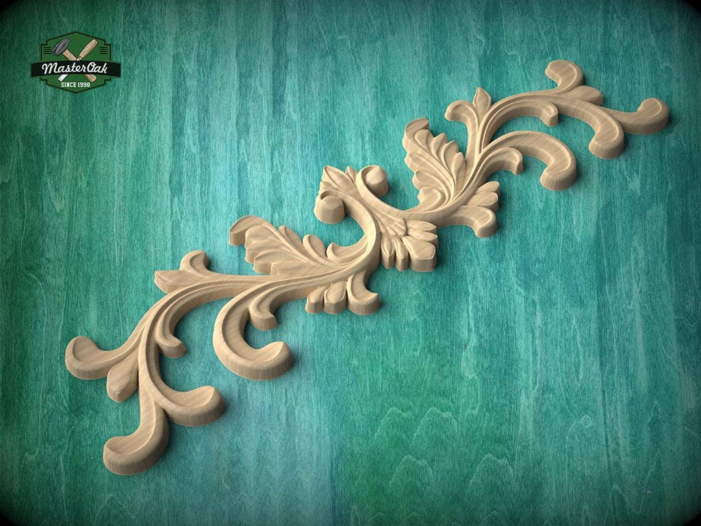 A decorative wooden carving with intricate scrollwork is displayed against a teal background.