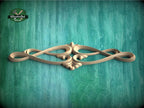 A decorative wooden carving with an intricate design is displayed against a textured green background.