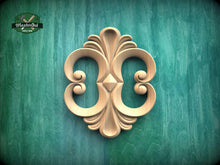 Load image into Gallery viewer, a decorative wooden carving on a green background.
