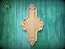 Load image into Gallery viewer, a decorative wooden panel with an intricate design, mounted on a green wooden surface.

