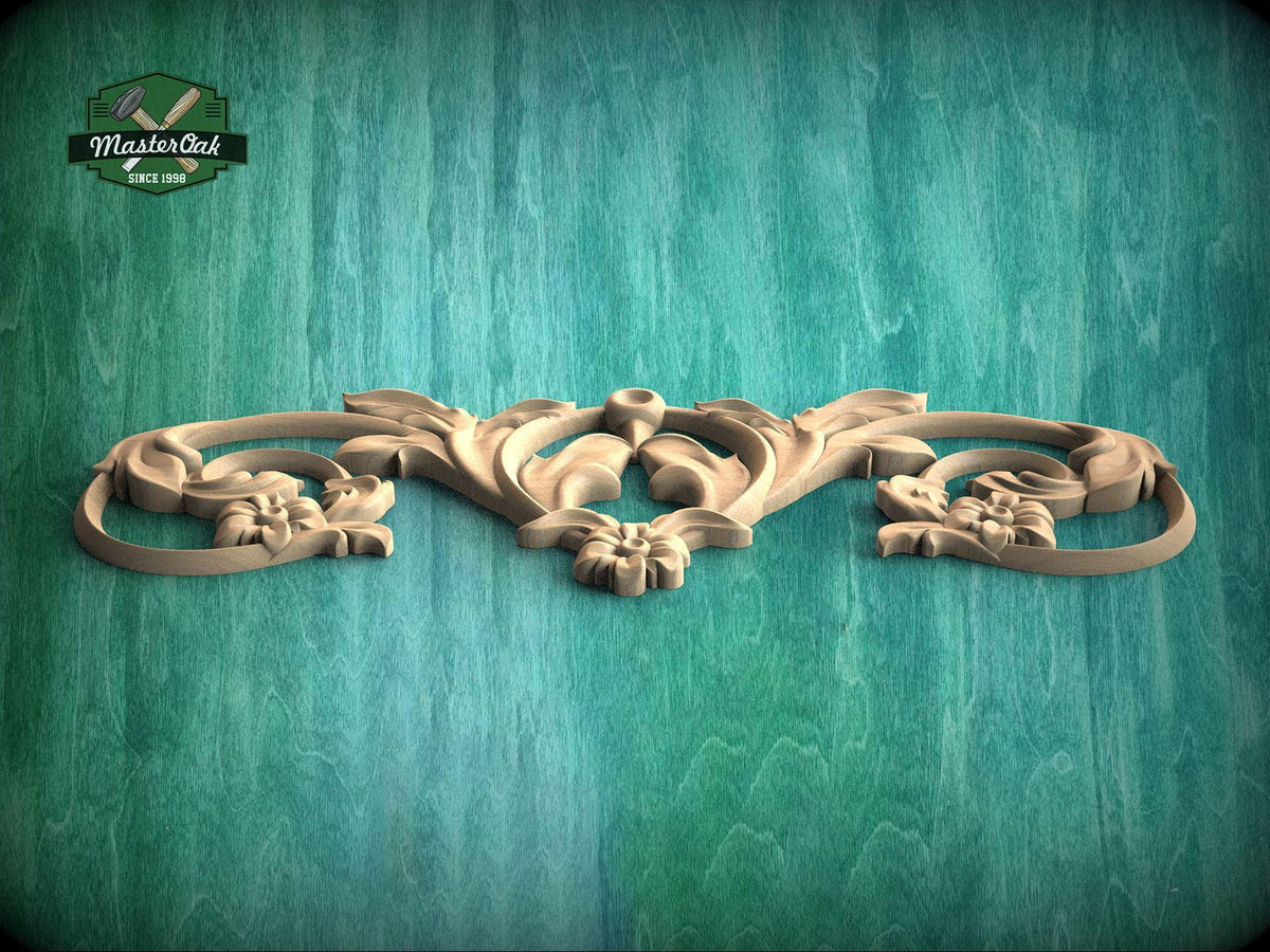 A decorative wooden carving with intricate floral and scroll designs is displayed against a textured green background.