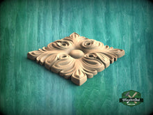 Load image into Gallery viewer, A decorative wooden panel with an intricate floral design, placed on a green textured background.
