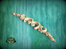 Load image into Gallery viewer, A decorative wooden carving with a scroll-like design is displayed against a teal-colored background.
