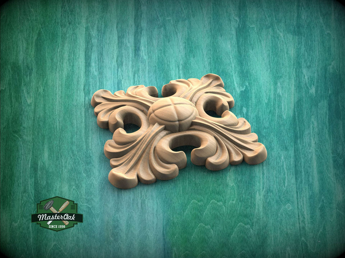 A wooden ornamental piece with a floral design sits on a green wooden surface.