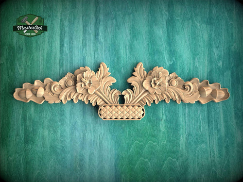 a wooden carving of a vase with flowers