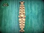a decorative wooden carving on a green background.
