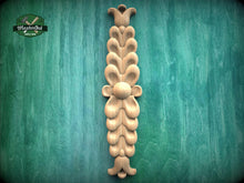 Load image into Gallery viewer, a decorative wooden carving on a green background.

