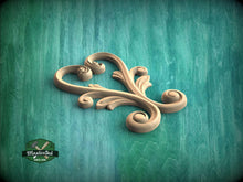 Load image into Gallery viewer, A wooden carving of a heart shape is displayed against a teal-colored background.
