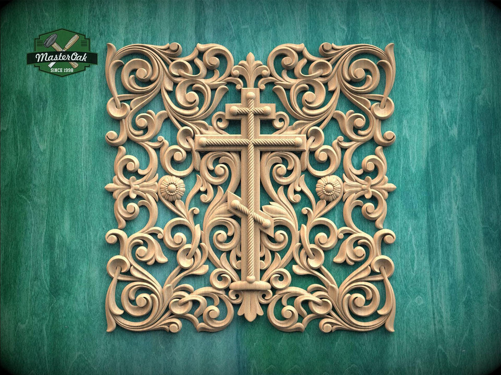 an ornate, carved wooden cross with intricate floral and scroll designs surrounding it, set against a green background.
