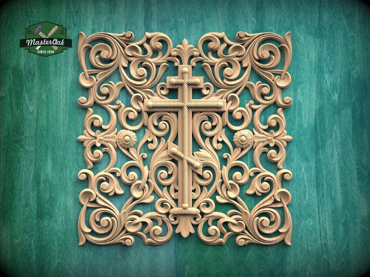 an ornate, carved wooden cross with intricate floral and scroll designs surrounding it, set against a green background.