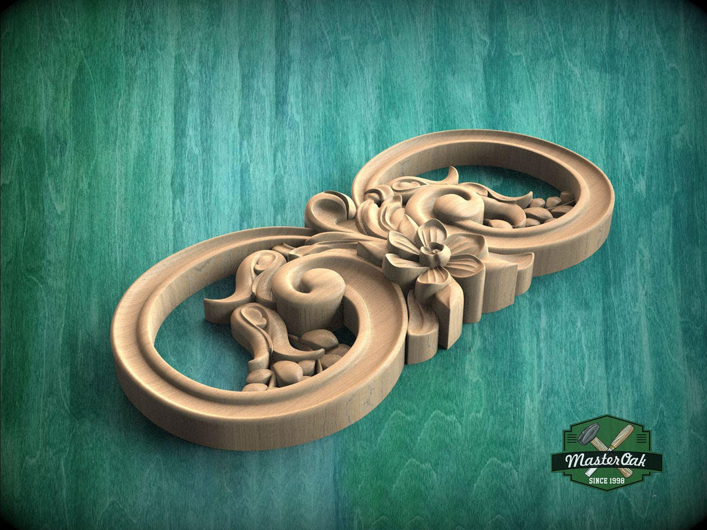 A wooden carving with intricate floral designs on a green background.