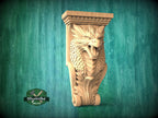 A carved wooden dragon head with a fierce expression is displayed against a green background.