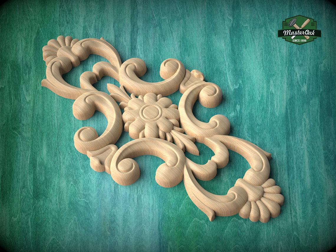A decorative wooden carving with intricate floral and scroll designs is displayed against a green background.
